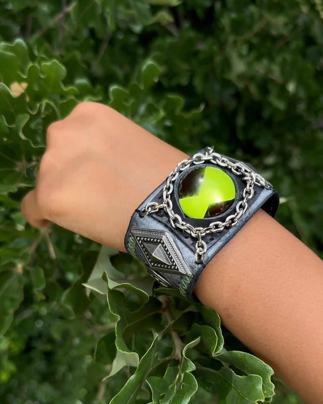 light green ben 10 omnitrix bracelet in a mans hand.