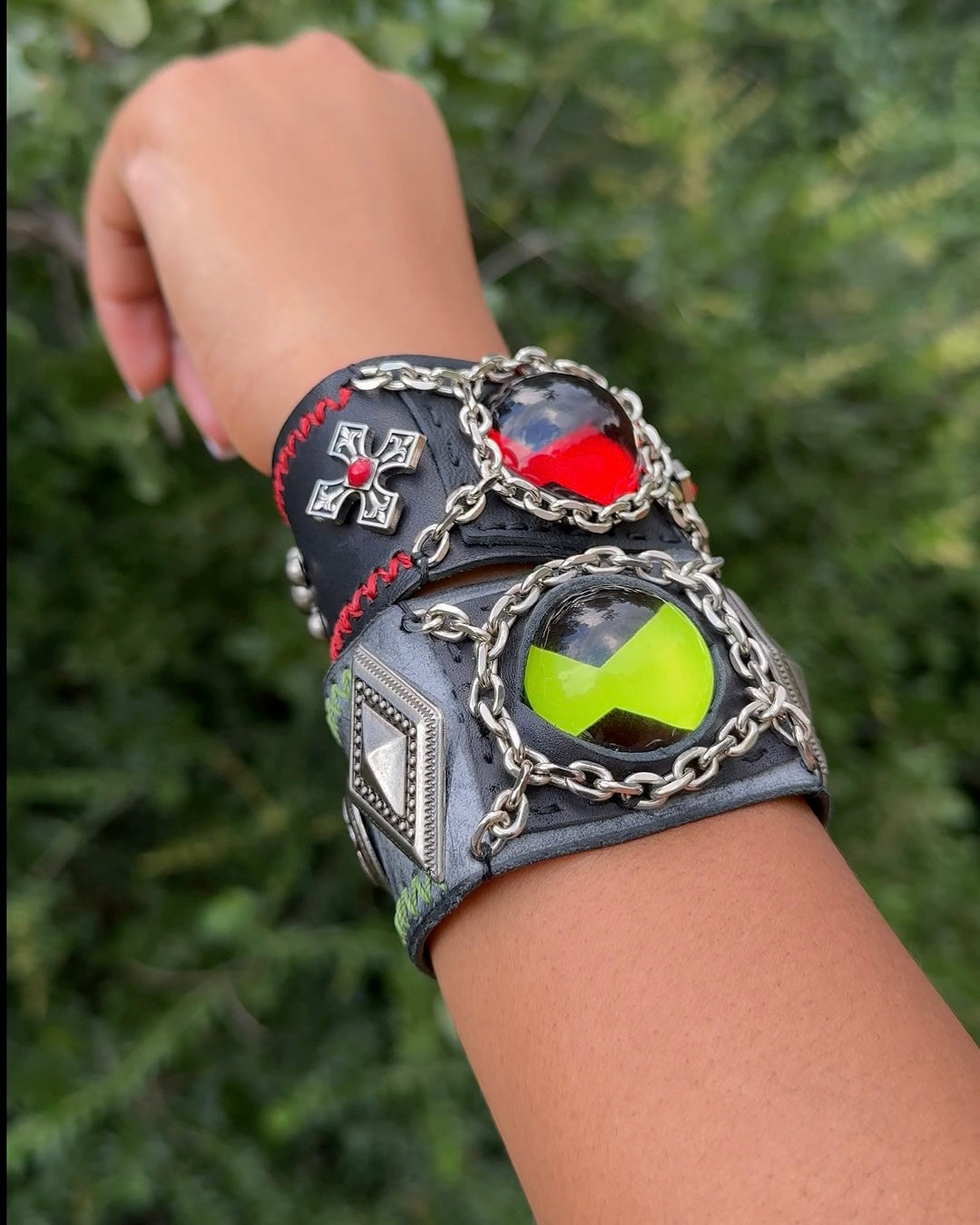 Red and green omnitrix bracelet being wear by a man.
