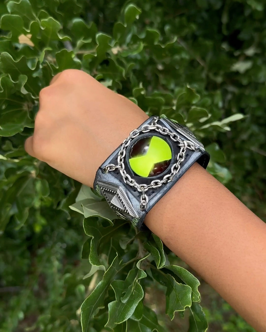 Green omnitrix bracelete in a childs wrist.