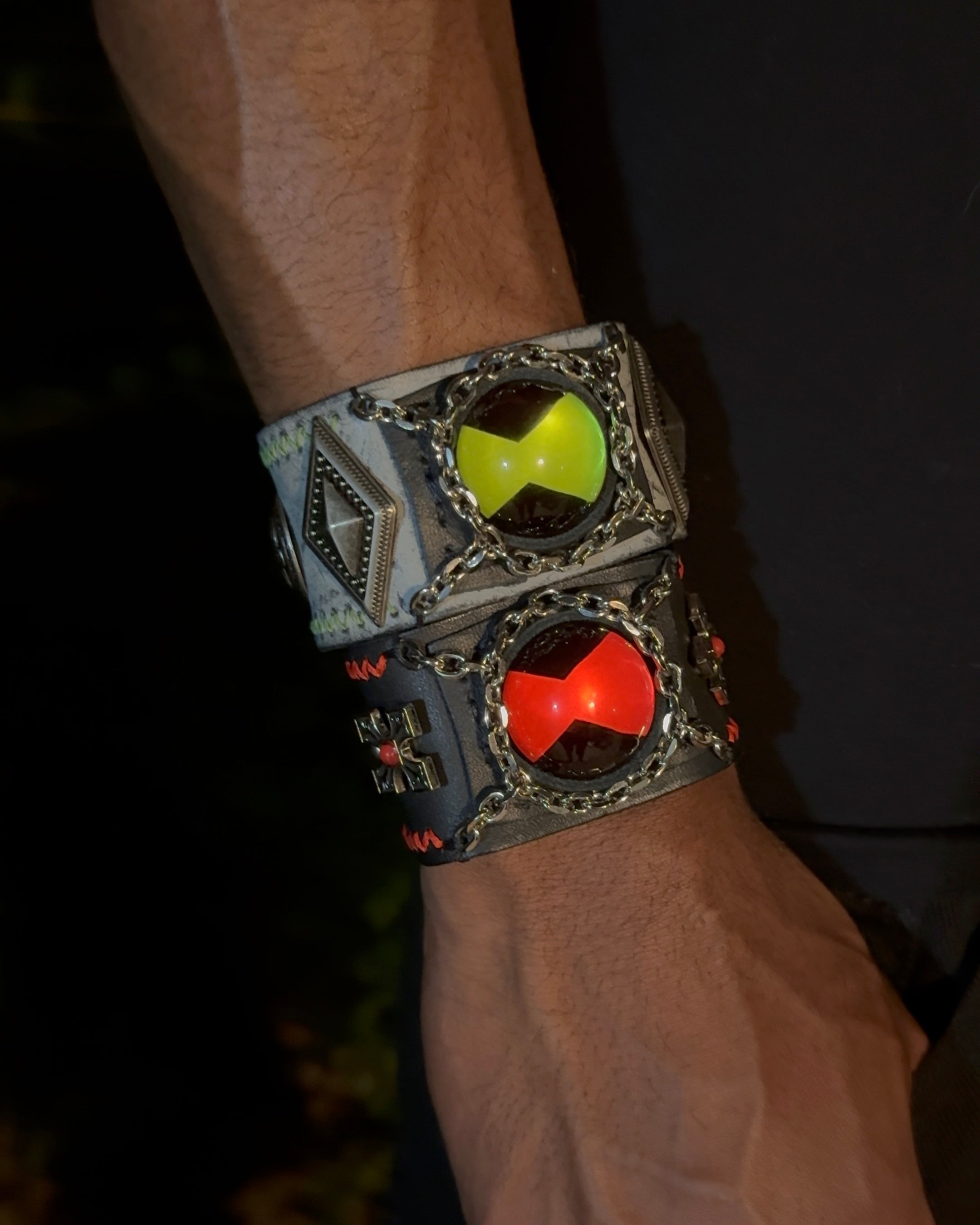 A man wearing two ben 10 omnitrix bracelet on his hand.