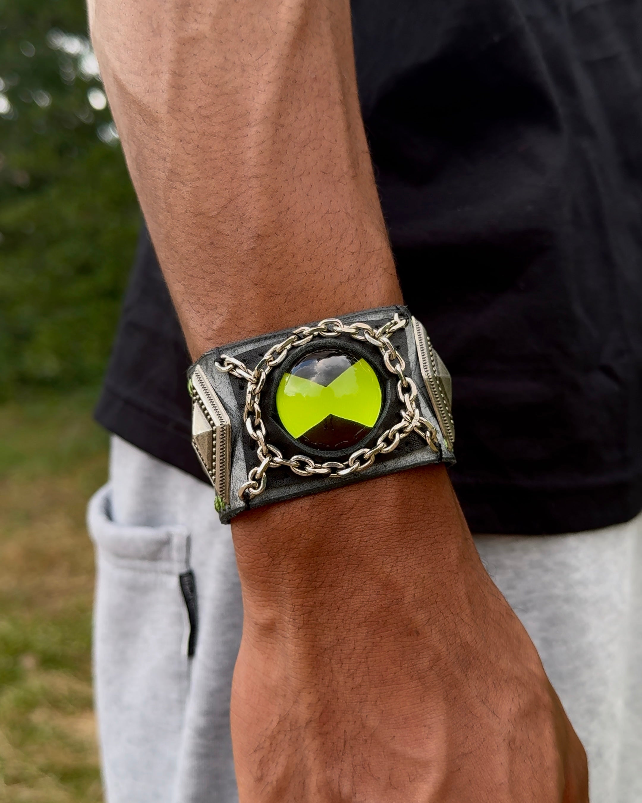 A close-up shot of a person's arm wearing alight green ben 10 omnitrix bracelet