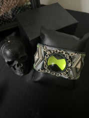 Green ben 10 omnitrix bracelet in a dark style  room.