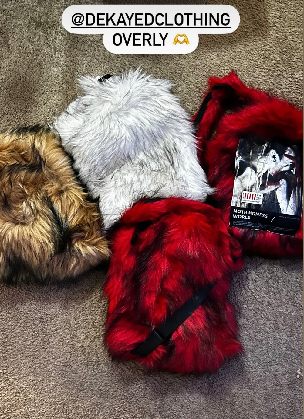An overhead view of four fluffy Plush Backpacks - Lost Series in brown, white, and two shades of red are shown lying on a carpeted floor.