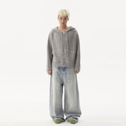A man firce look while wearing a baggy washed  jeans.
