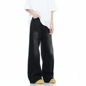 Close-up of a person wearing stylish, slightly distressed washed wide leg jeans. While hands on pocket.

