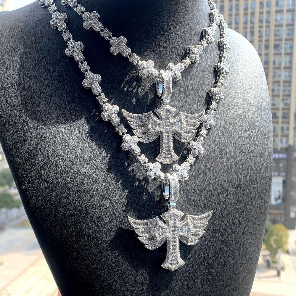 Two sparkling Winged Angel Zircon Diamond Necklaces, each featuring a detailed winged angel pendant, are displayed on a black bust against an outdoor background.