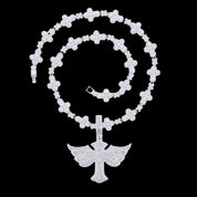 A Winged Angel Zircon Diamond Necklace with a detailed winged angel pendant hangs from a sparkling, diamond-studded chain against a dark background.