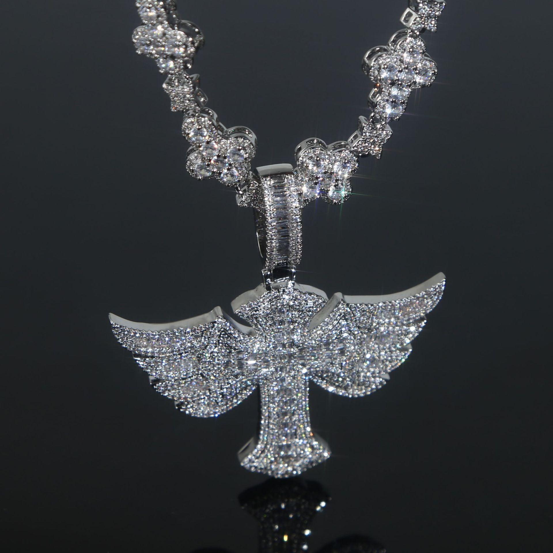 A gleaming Winged Angel Zircon Diamond Necklace, featuring a large, intricate winged angel pendant, sparkles against a dark, reflective surface.