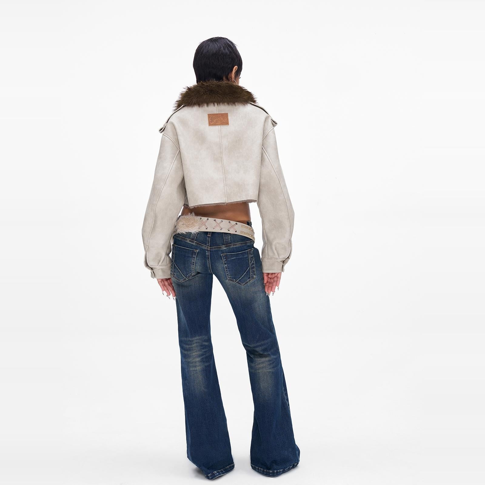 A woman wearing Fur collar cropped Jacket back angle.
