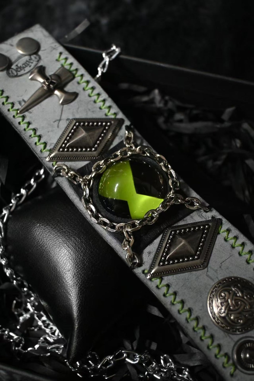A green omnitrix bracelet being display in a horizontal angle.
