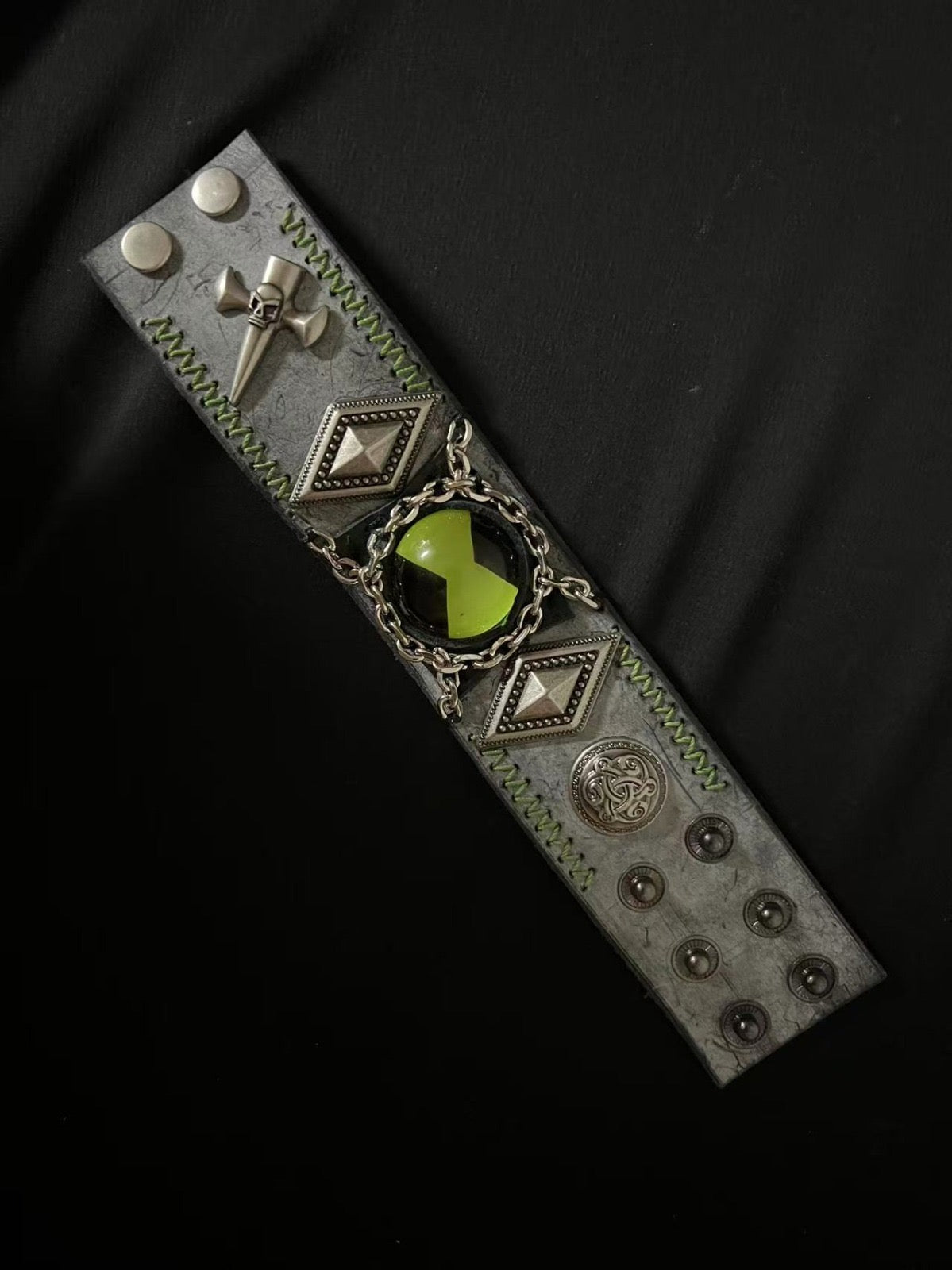 Green Omnitrix bracelet being displayed horizontally.