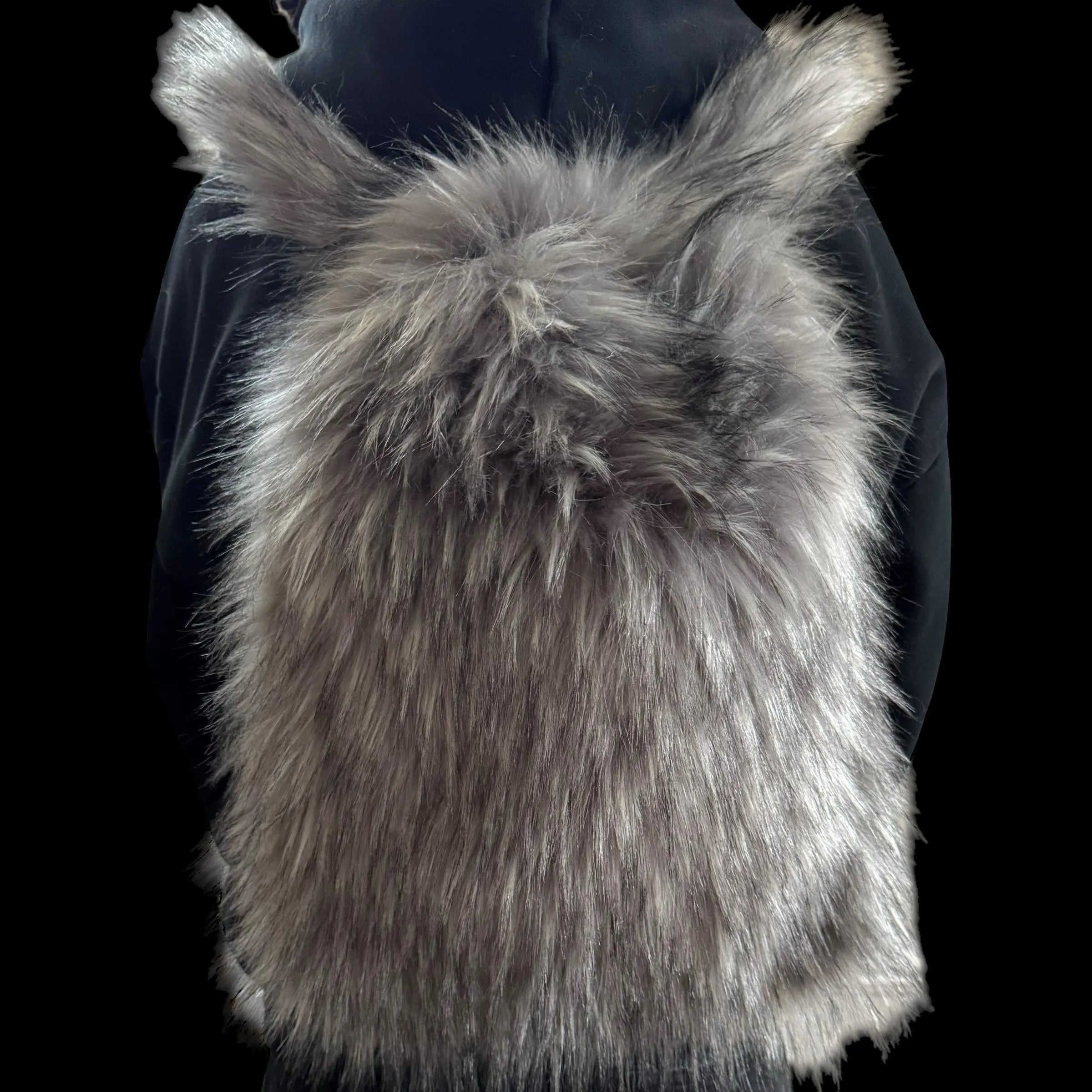 A luxurious grey Plush Backpacks - Lost Series with a fluffy, shaggy texture is worn on a person's back, set against a dark background.