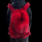 A plush red and black Plush Backpacks - Lost Series with bunny ears is worn on a person's back, set against a dark background.