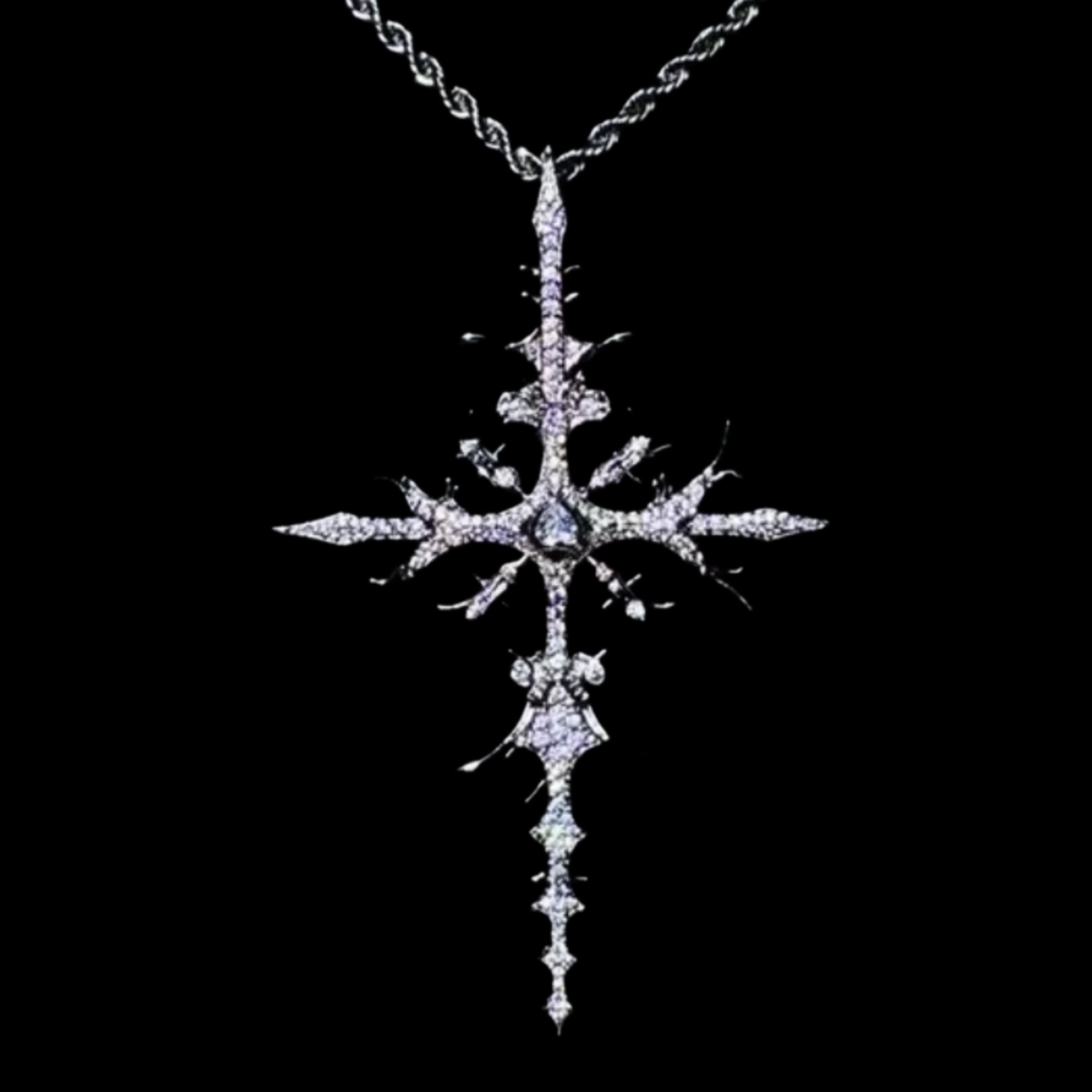 A dazzling WHITE GOLD APOSTLE NECKLACE pendant, featuring an intricate, diamond-encrusted cross design with a central gem, hangs from a rope chain against a dark background.