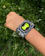 Green omnitrix bracelete in a childs wrist.