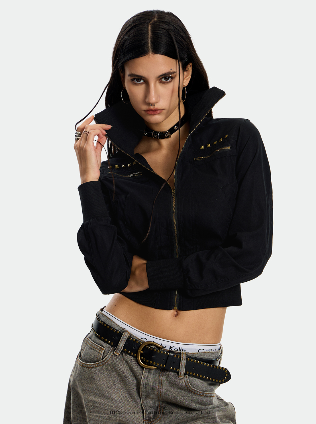 A model is shown in two poses wearing a black Rebel studded Camo Jacket with studded detailing.