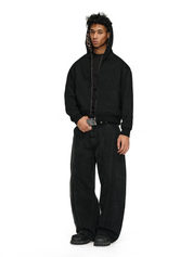 A man wearing black Leopard Jacket with a matching leopard-print lining in the hood, baggy black jeans with a striped belt, and chunky black shoes.