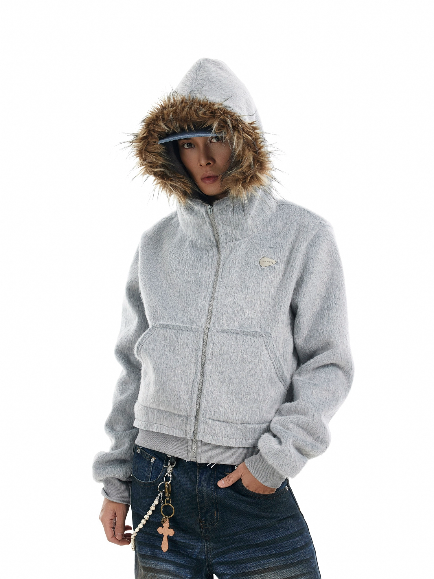 A person models a &quot;Mens Faux Fur Hooded Jacket&quot; in light grey, featuring a prominent brown faux fur trim around the hood