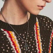 A man wearing MIDNIGHT IRIS" BLACK DIAMOND CROSS NECKLACE in side angle.