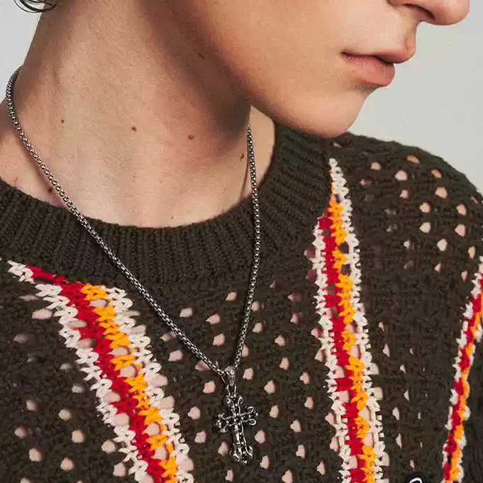 A man wearing MIDNIGHT IRIS" BLACK DIAMOND CROSS NECKLACE in side angle.