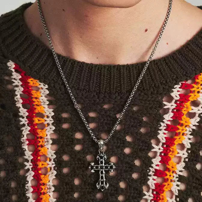 A man wearing MIDNIGHT IRIS" BLACK DIAMOND CROSS NECKLACE 