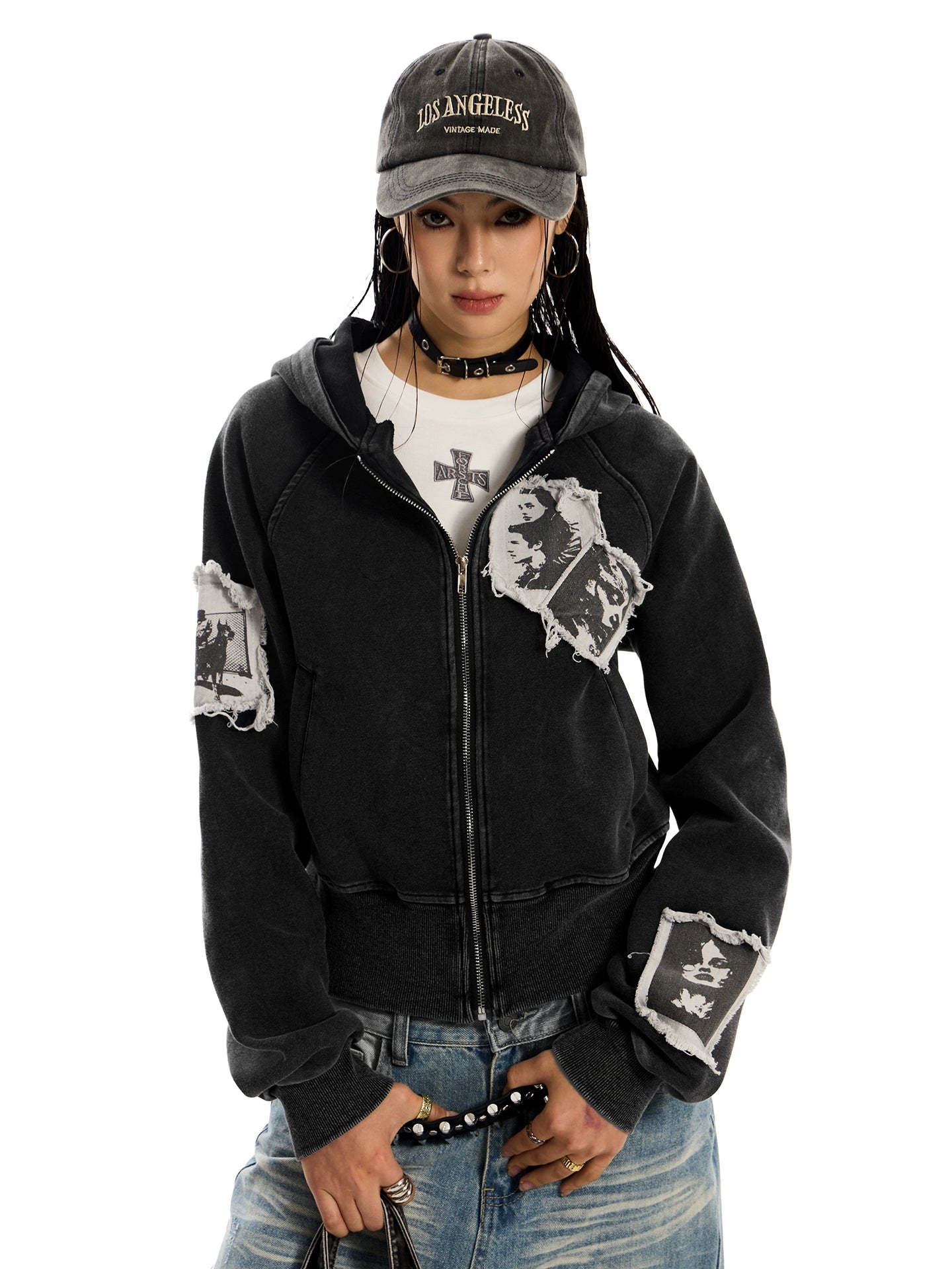 A woman with a "Los Angeles" cap and choker wearing a cropped, distressed, black, pocketless "Punk RockStar" hoodie.