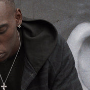 A man with black jacket wearing ABYSS STAR EARRINGS.