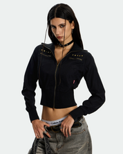 A woman with a black choker and a black handbag visible in the full-length shot.