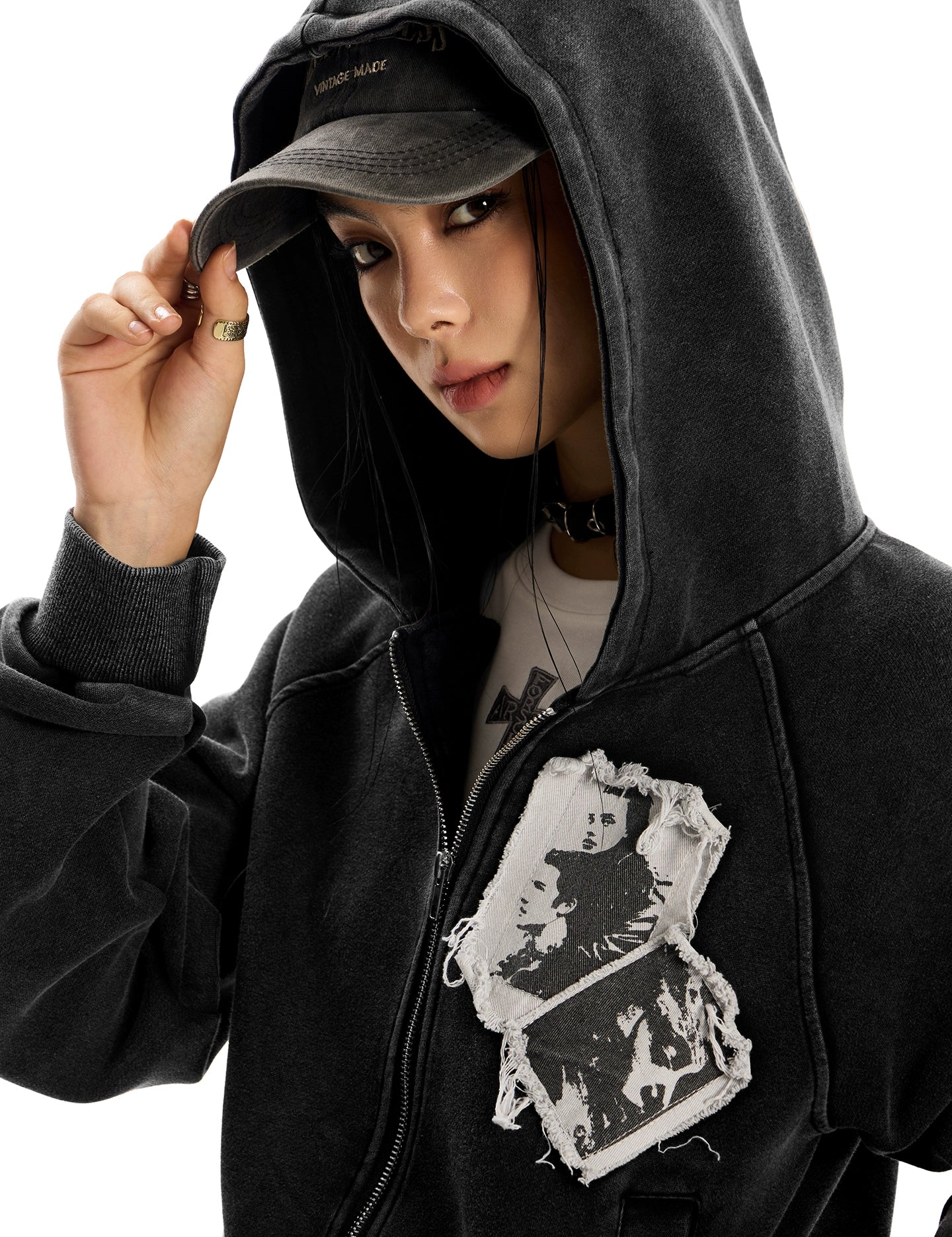 Full-body shot of a woman in a distressed black pocketless "Punk RockStar" hoodie.