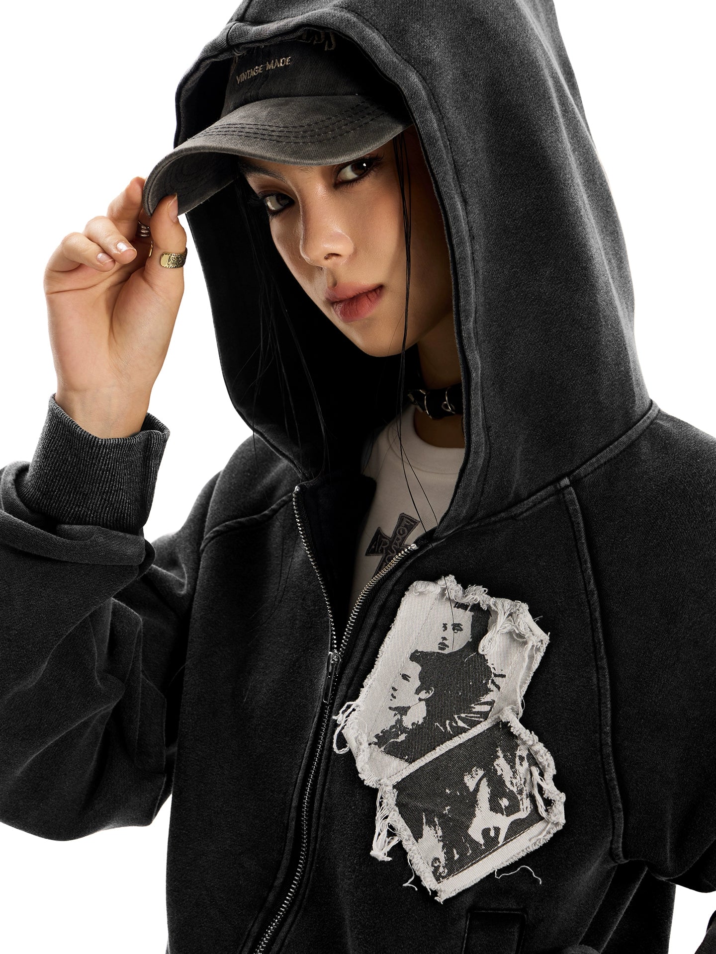 Full-body shot of a woman in a distressed black pocketless "Punk RockStar" hoodie.