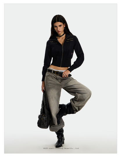 A young woman modeling an UrbanRebel Camo Jacket with a matching black skirt, knee-high boots, and a black purse. 