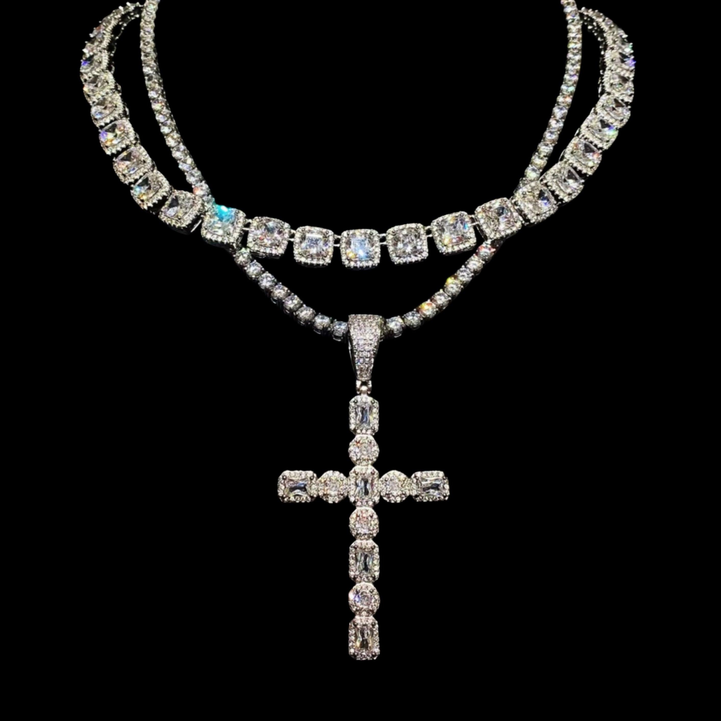 A shimmering "GODFATHER CROSS NECKLACE" made of multiple diamond-encrusted chains and a large cross pendant is displayed against a dark background.