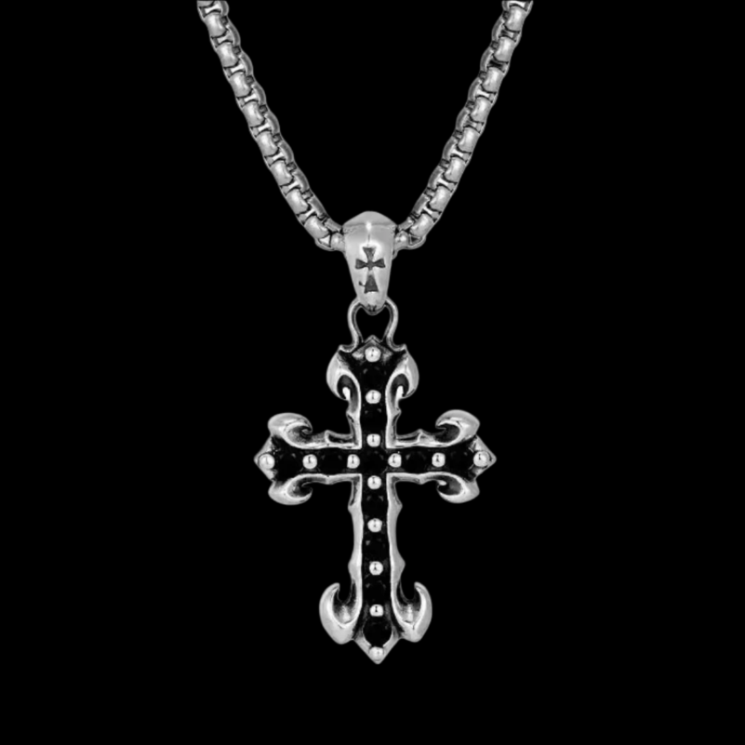 A detailed silver cross pendant "MIDNIGHT IRIS' BLACK DIAMOND CROSS NECKLACE with a black-filled design.