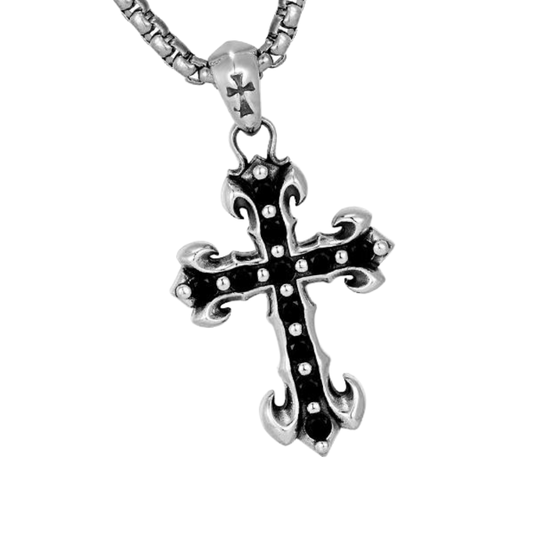 A close-up product shot shows a "MIDNIGHT IRIS" BLACK DIAMOND CROSS NECKLACE, featuring a detailed silver cross pendant with a black inset and small accents, hanging from a thick chain against a dark background.