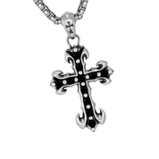 A close-up product shot shows a "MIDNIGHT IRIS" BLACK DIAMOND CROSS NECKLACE, featuring a detailed silver cross pendant with a black inset and small accents, hanging from a thick chain against a dark background.