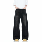  A model wears dark washed wide leg jeans with a white t-shirt.