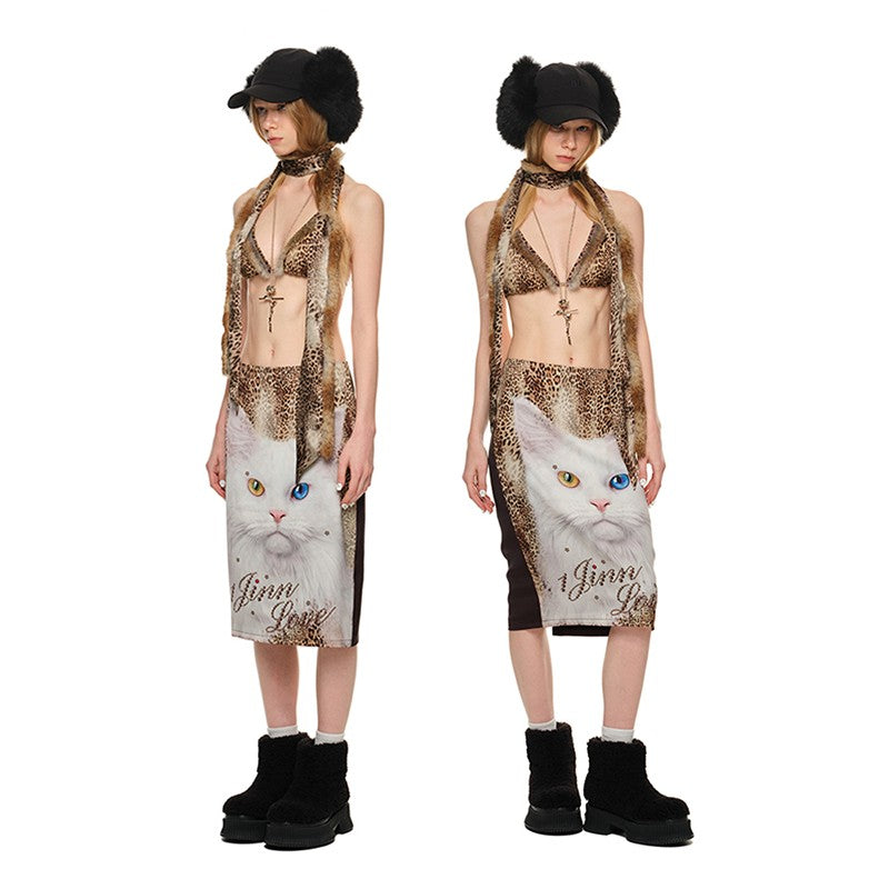 
A full-length product image shows two views of a model wearing a Leopard Print Triangle Bikini top paired with a skirt featuring a large white cat print at dekayed clothing.