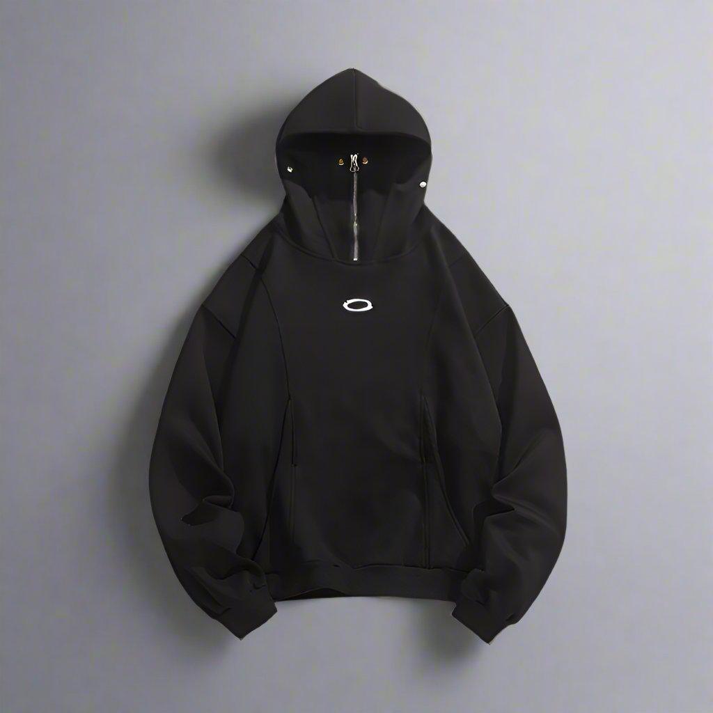 A plain black masked hoodie with a zipper is shown against a white background.