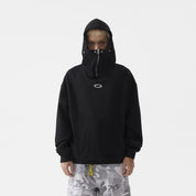 A young man wearing a black hoodie with mask that zips up to cover the lower half of his face.