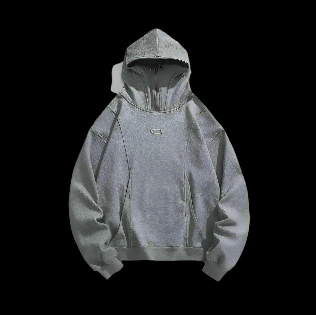 A plain gray hoodie with mask is displayed on a black background, with its zipper and hood featuring eyelets.