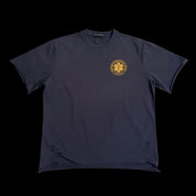 A dark blue "Masochist DIVISION TEE" featuring a gold circular emblem with a star of life symbol and text on the front.