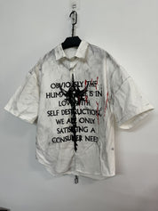 A white, distressed men's graffiti t-shirt with short sleeves, featuring black text.