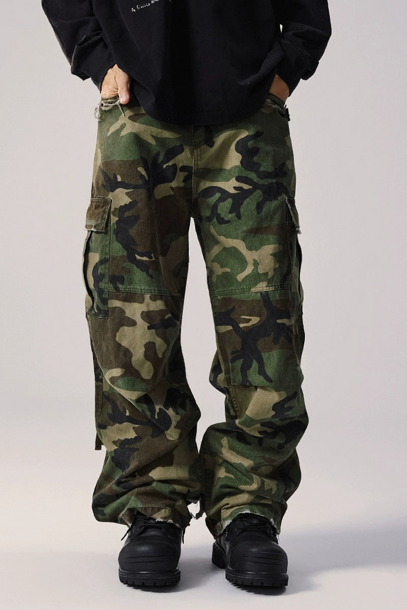 A man wearing dark Vintage Camouflage Cargo Pants.