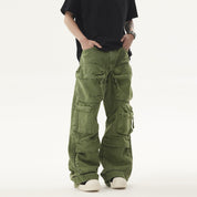 A person wears a black t-shirt and green Heavy duty Vibe Cargo Jeans with numerous large pockets, paired with white sneakers.