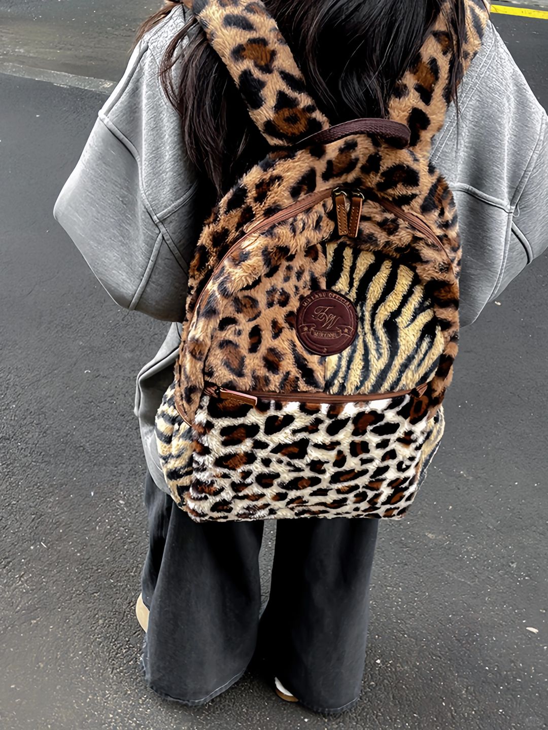 Showing a woman Multi Leopard Print Plush Backpack.