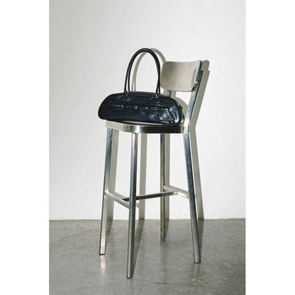 Plaque Leather G*n Bag on top of the stool - Dekayed