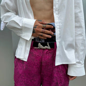man holding his playboy belt.
