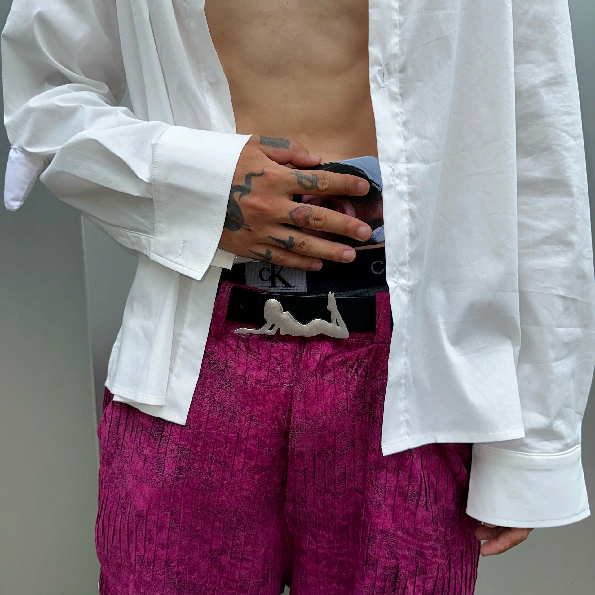 man holding his playboy belt.