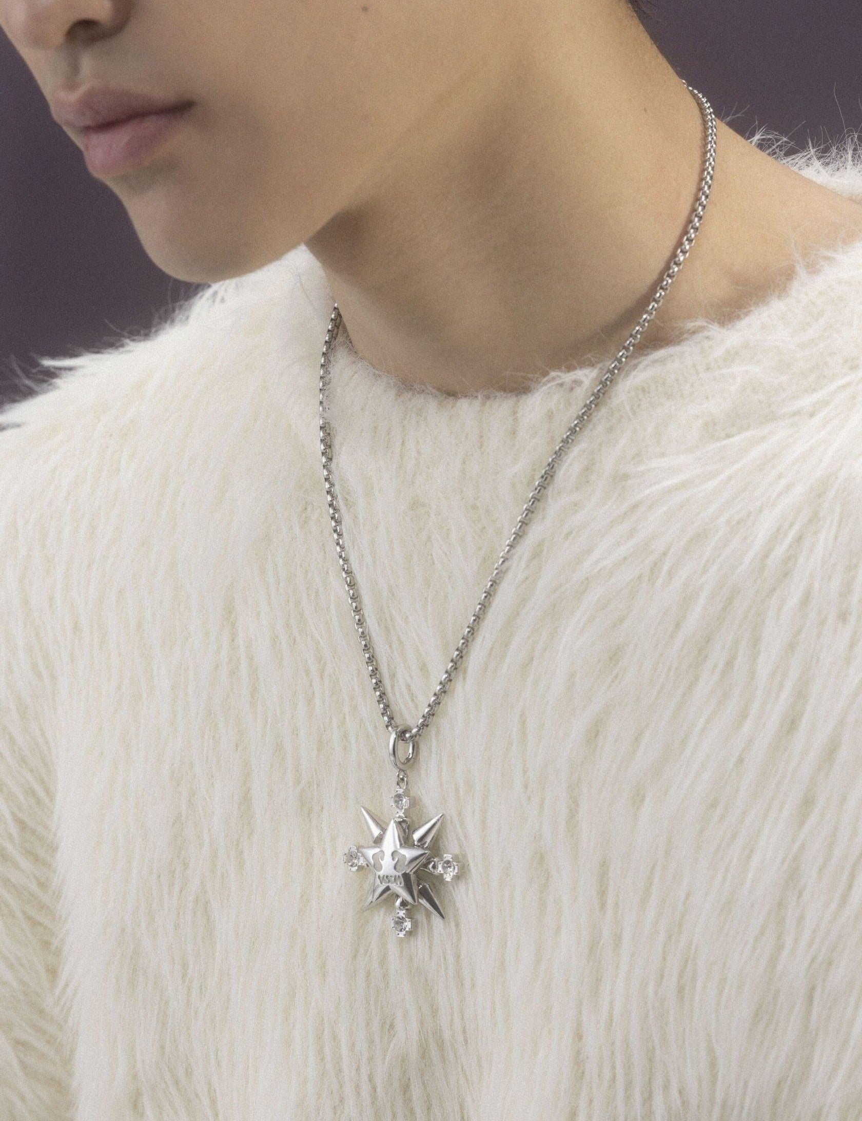 A person wearing a fluffy white sweater displays a silver "VSCH Lucky Star Necklace" with a detailed star pendant.