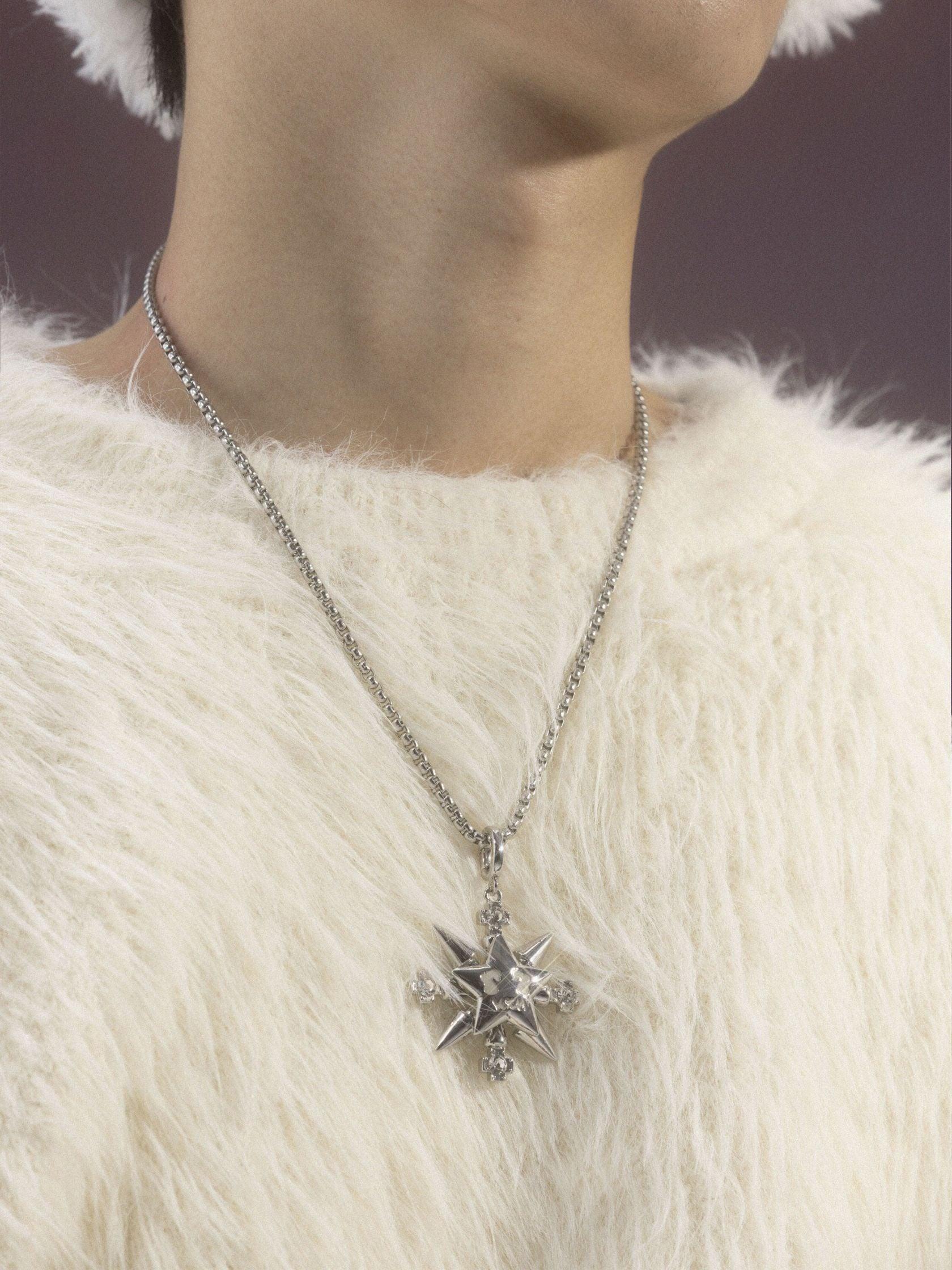 A close-up shot shows a person wearing a fuzzy white sweater, adorned with a "VSCH Lucky Star Necklace" featuring a prominent star pendant.